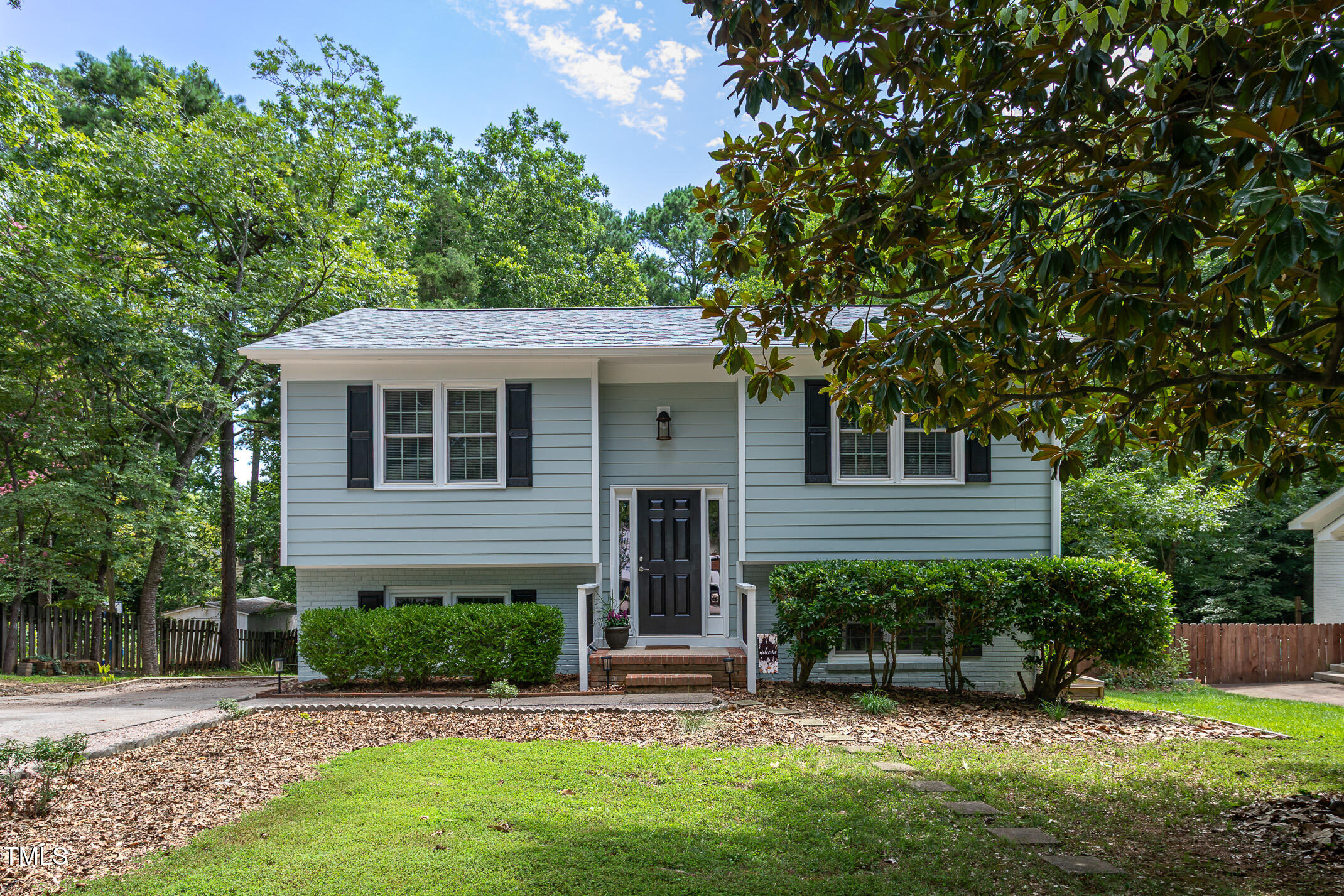 7412 Mine Shaft Road Raleigh, NC 27615 - Photo 1 of 16 a view of a house with a yard plants and a large tree