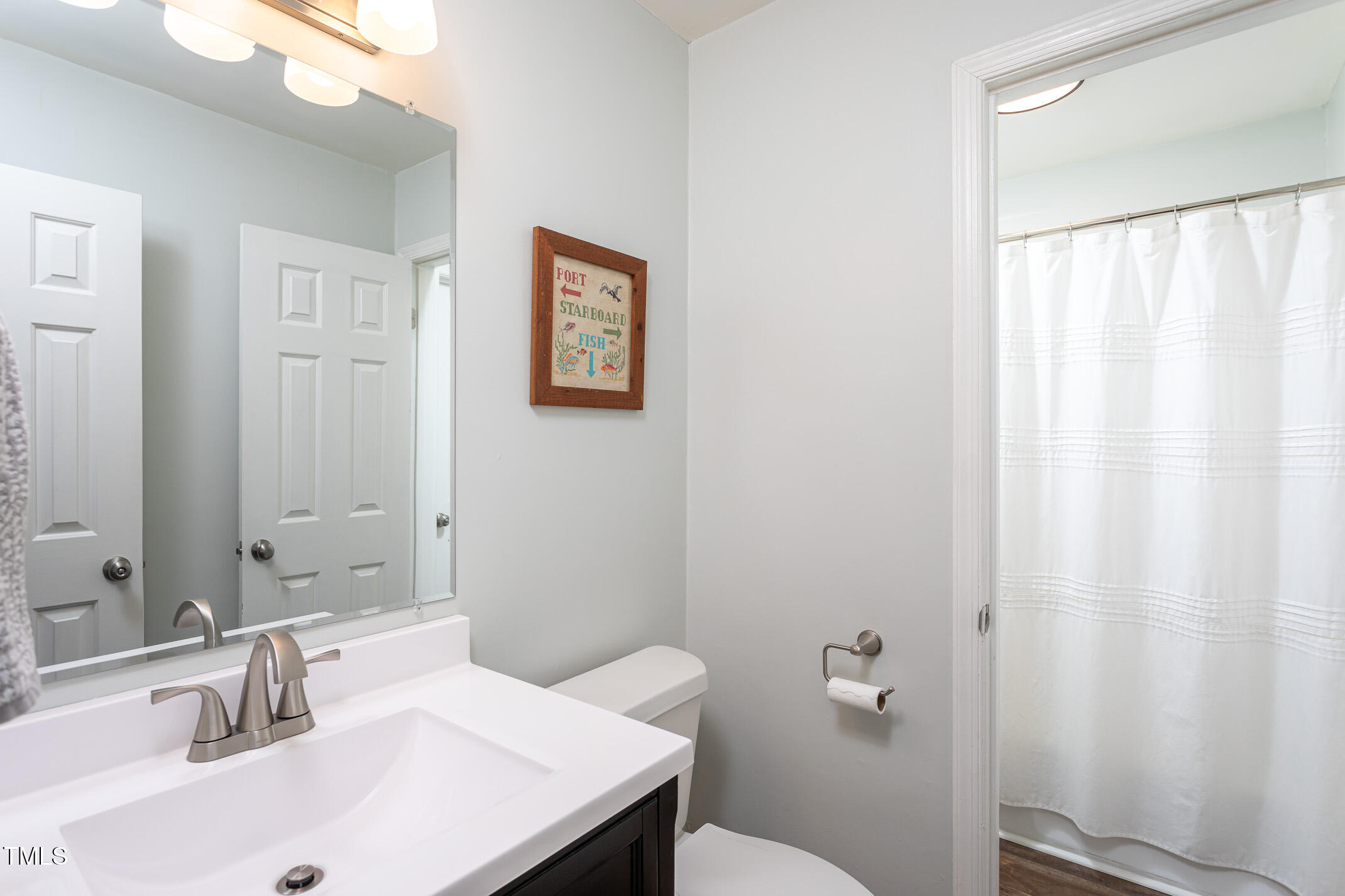 7412 Mine Shaft Road Raleigh, NC 27615 - Photo 8 of 16 a bathroom with a sink and a toilet