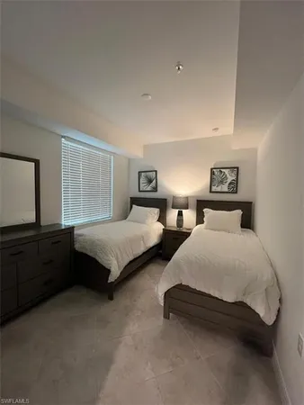 a spacious bedroom with two beds and a dresser