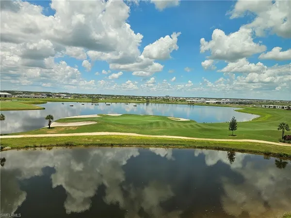 a view of a lake with houses in the back