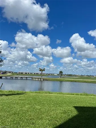 a view of a lake with houses in the back