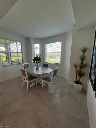 a dining room with furniture and window
