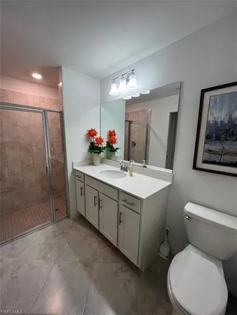 a bathroom with a double vanity sink mirror and toilet