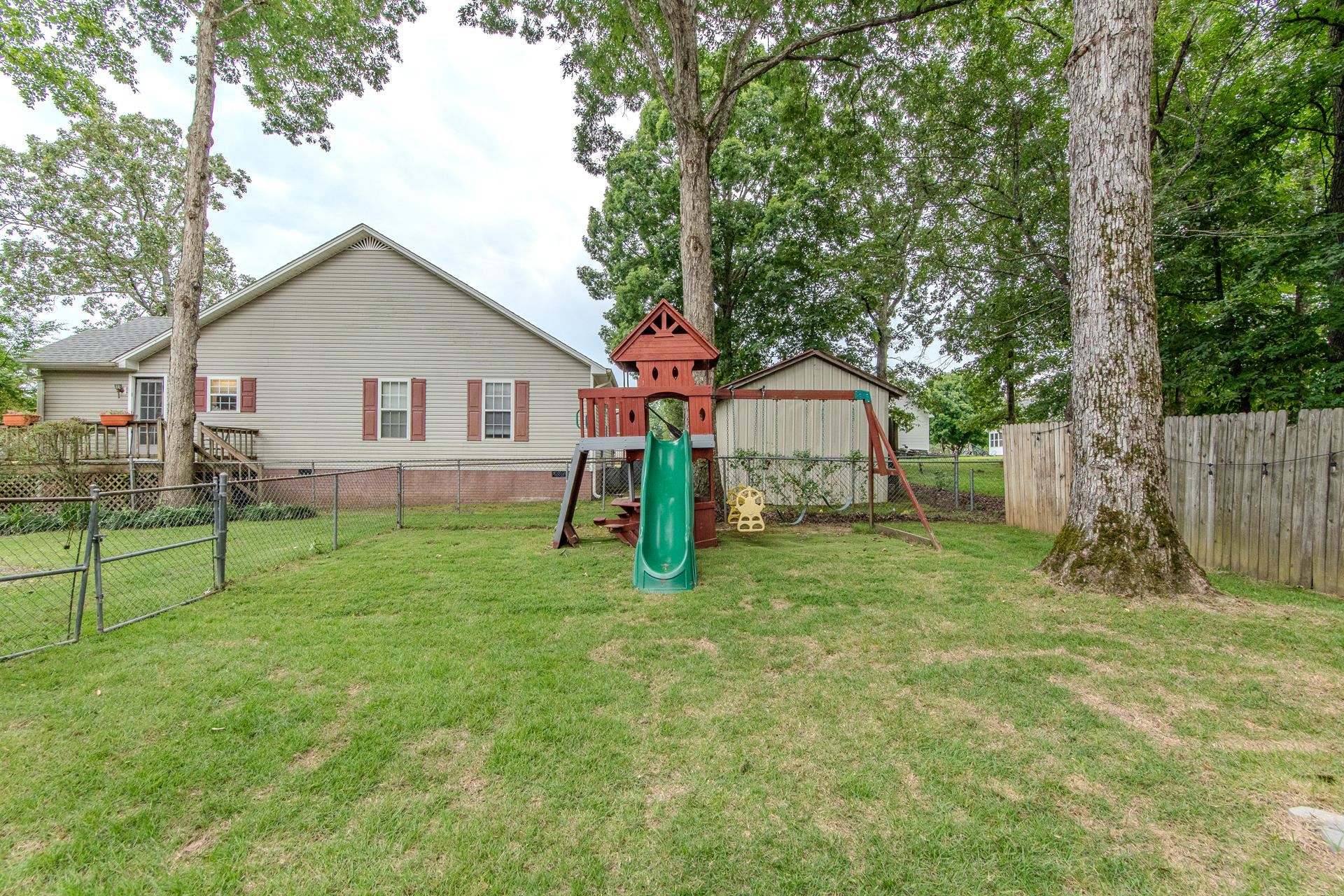 80 Tom Way Savannah, TN 38372 - Photo 15 of 33 a view of a house with backyard and a tree
