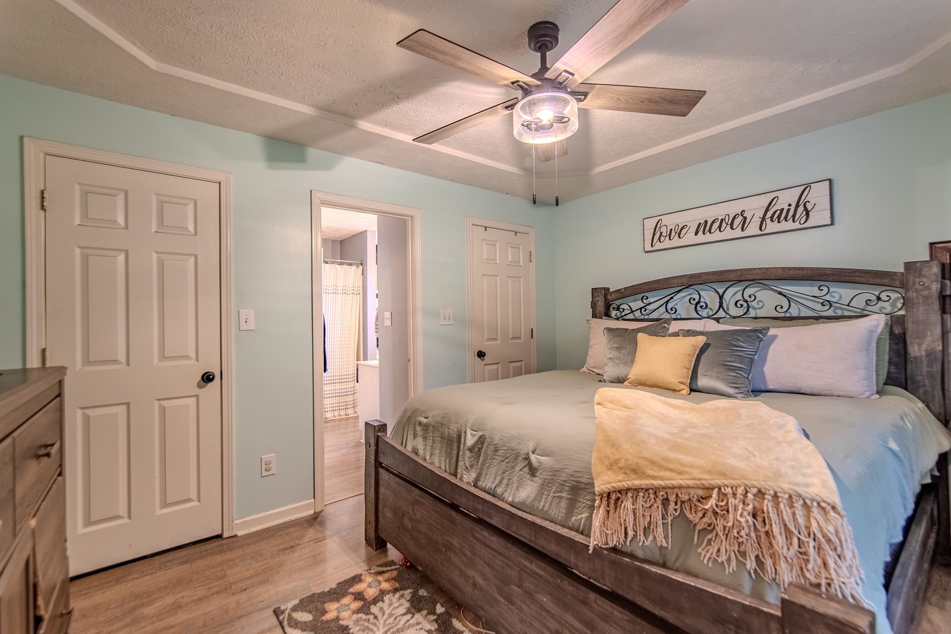80 Tom Way Savannah, TN 38372 - Photo 23 of 33 a bedroom with a large bed and a chandelier