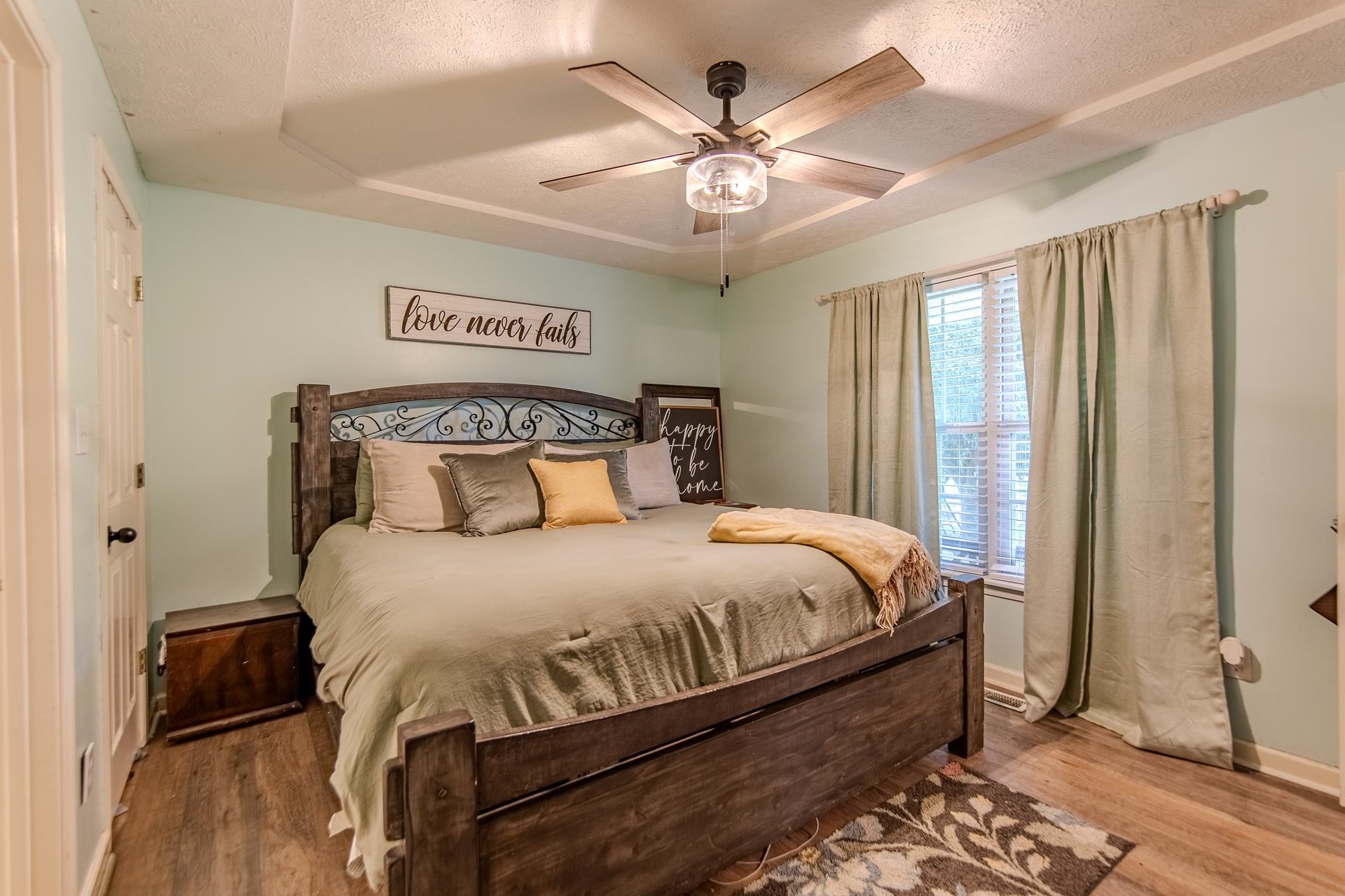 80 Tom Way Savannah, TN 38372 - Photo 24 of 33 a bedroom with a large bed and a chandelier