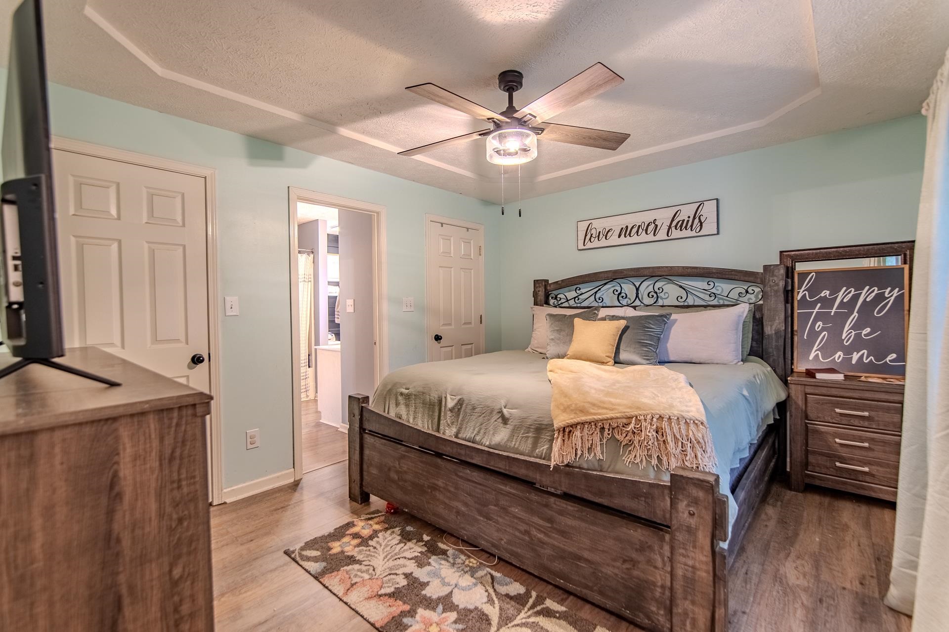 80 Tom Way Savannah, TN 38372 - Photo 25 of 33 a bedroom with a bed and a chandelier