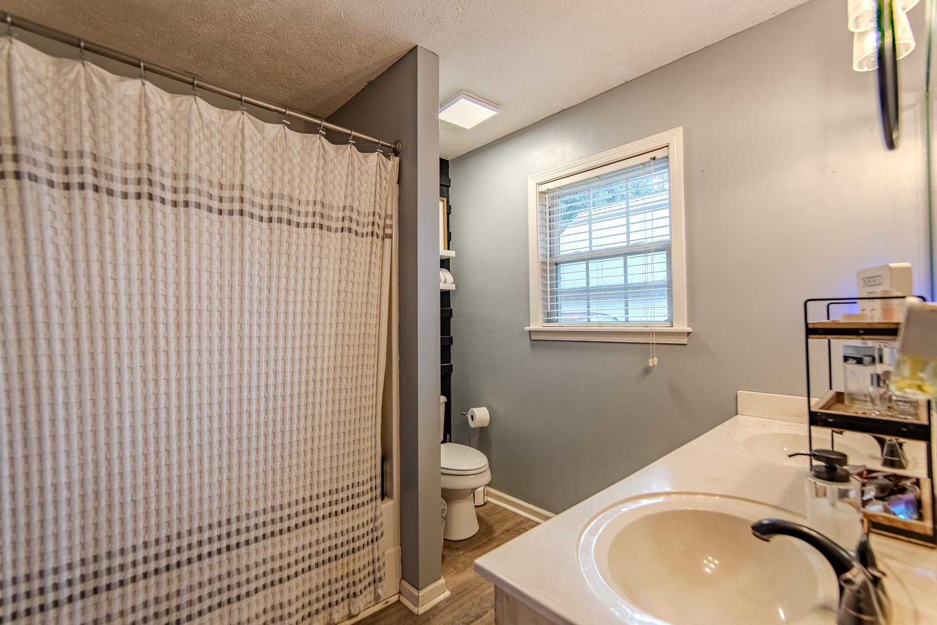 80 Tom Way Savannah, TN 38372 - Photo 26 of 33 a bathroom with a sink a toilet and shower curtain