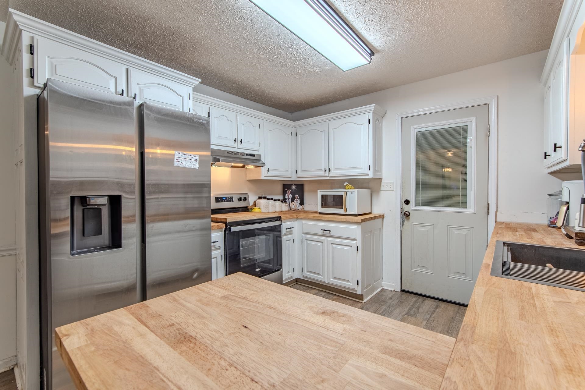 80 Tom Way Savannah, TN 38372 - Photo 9 of 33 a kitchen with a refrigerator sink and cabinets