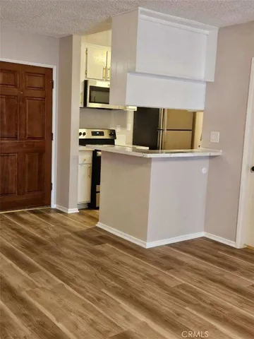 a view of kitchen and wooden floor