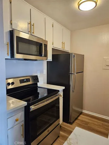 a kitchen with a stove and a microwave