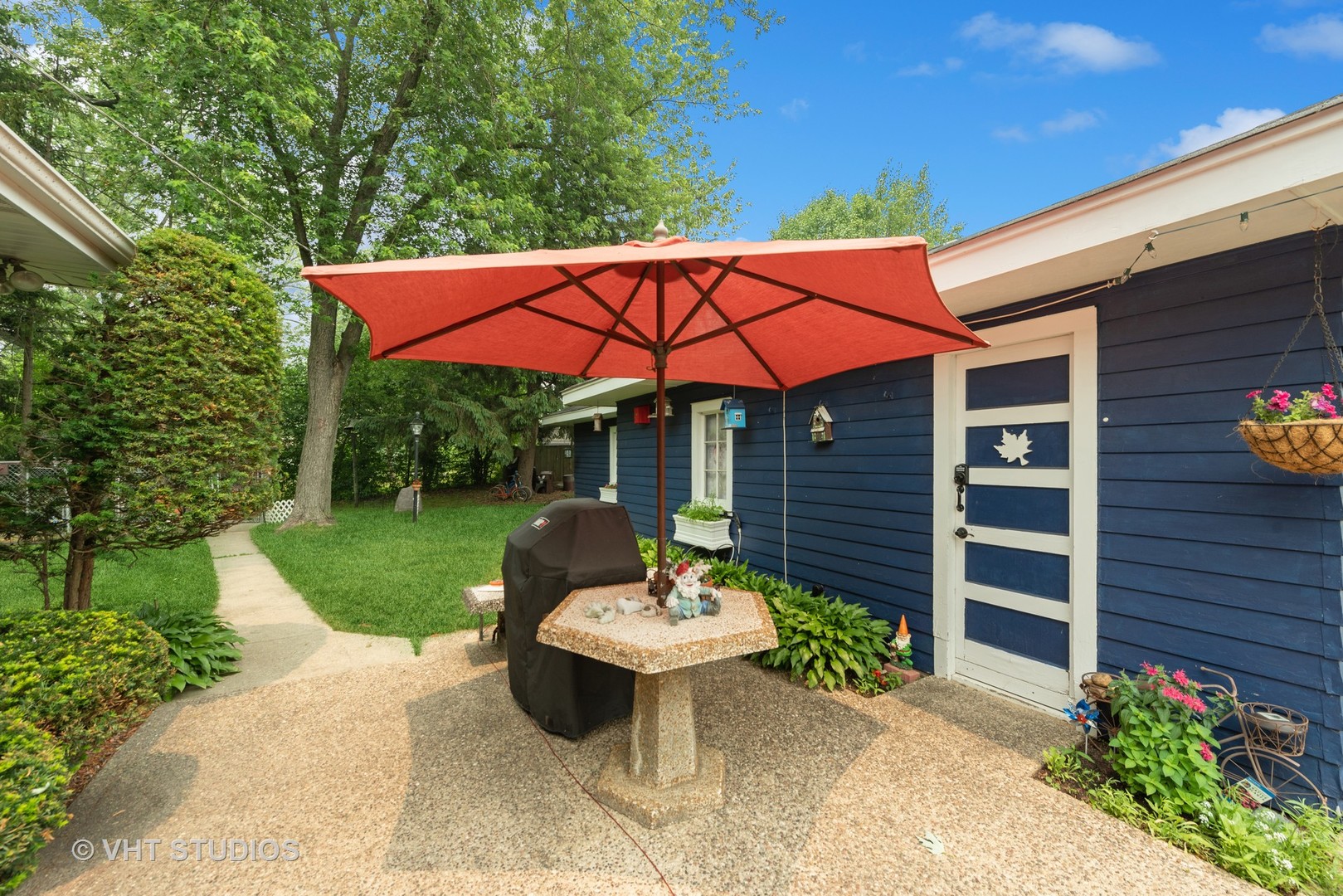 76 Golfview Road Lake Zurich, IL 60047 - Photo 5 of 24 a view of a patio with a table and chairs under an umbrella