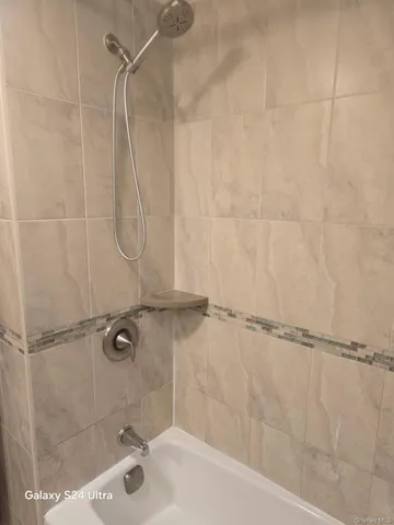 a bathroom with a shower and a bath tub