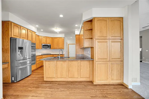 a view of a refrigerator in kitchen and wooden floor