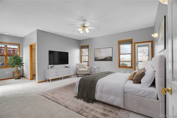 a spacious bedroom with a bed and a flat screen tv