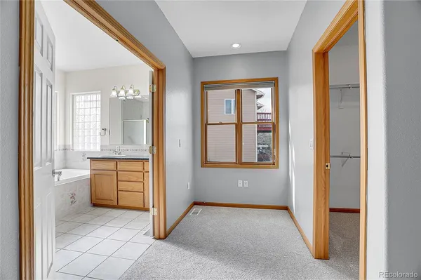 an empty room with windows and cabinet