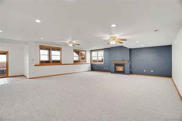a view of an empty room with window and cabinet