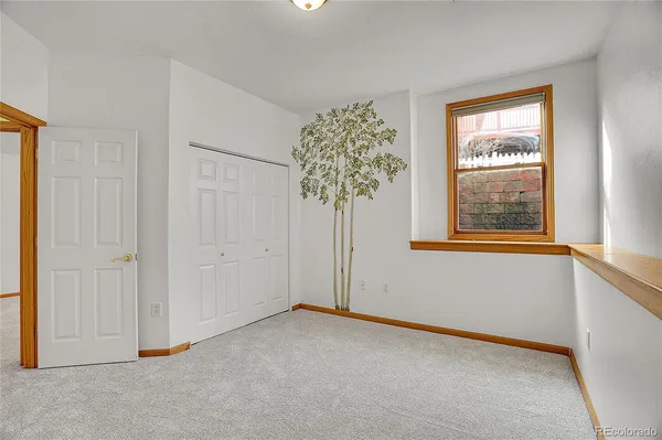 an empty room with windows and closet