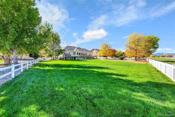 a view of green field with house in the background
