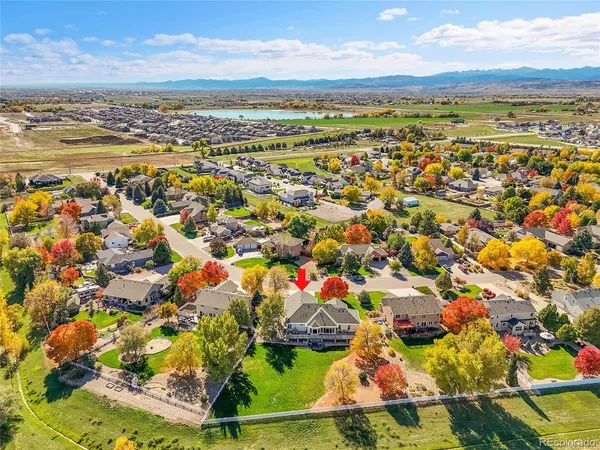 an aerial view of a house with a yard and pool