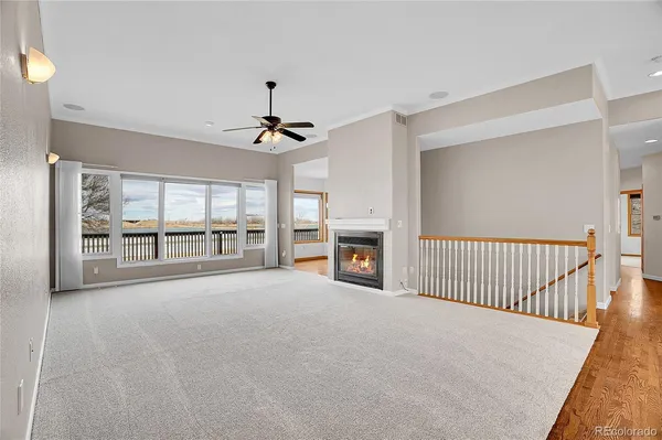 a view of an empty room with a fireplace and a window
