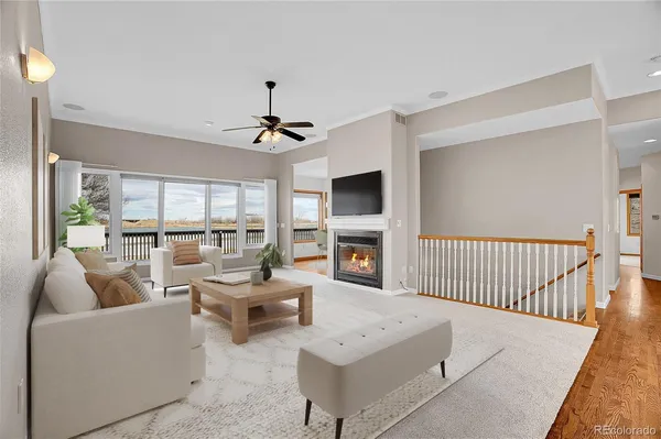 a living room with furniture a fireplace and a flat screen tv