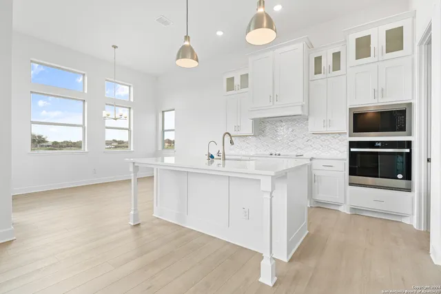 a kitchen with stainless steel appliances granite countertop a sink and cabinets