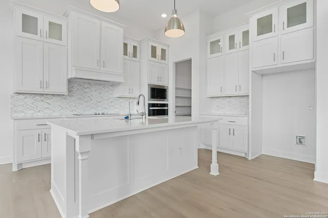 an empty room with a window and a ceiling fan