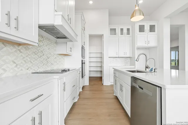 a bathroom with double vanity and a shower