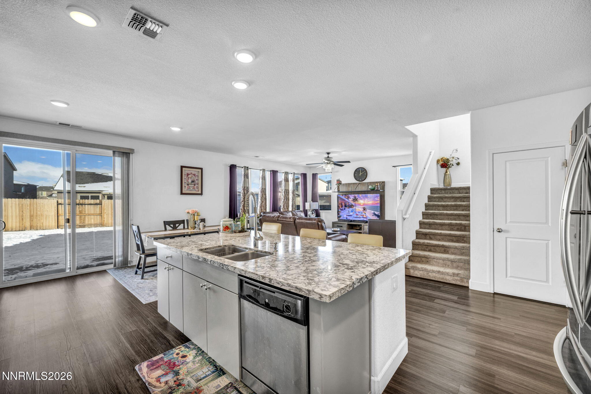 969 Estuary Circle Reno, NV 89506 - Photo 11 of 59 a very nice looking room with kitchen island a wooden floor