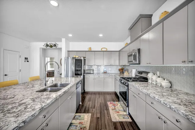 a kitchen with a sink stove cabinets and refrigerator