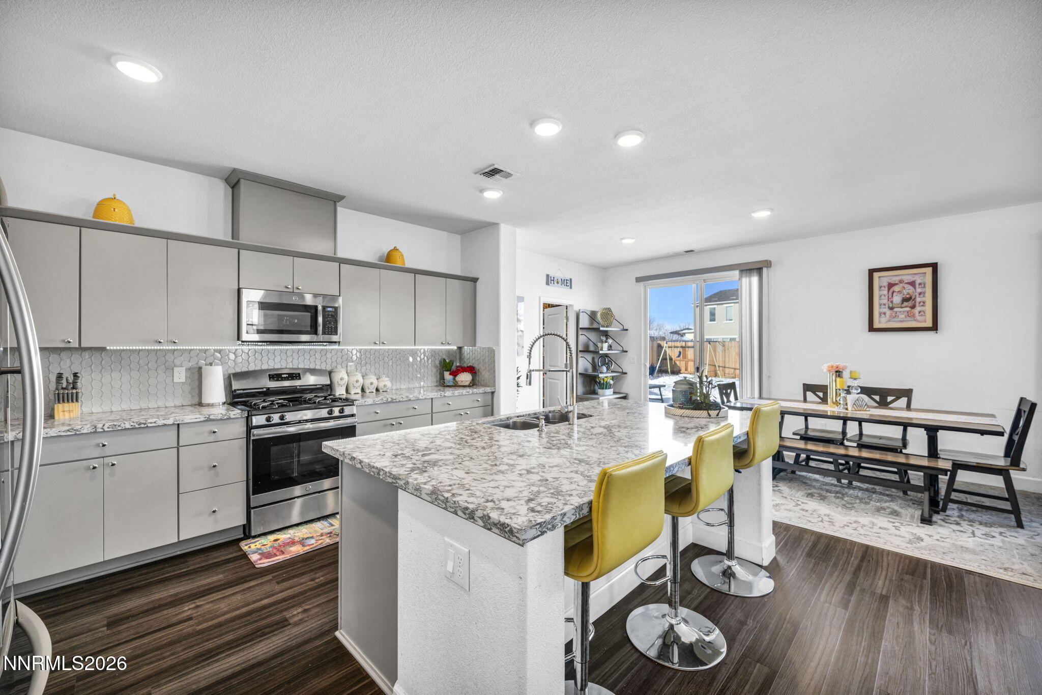 969 Estuary Circle Reno, NV 89506 - Photo 22 of 59 a open kitchen with stainless steel appliances granite countertop a stove and a wooden floors