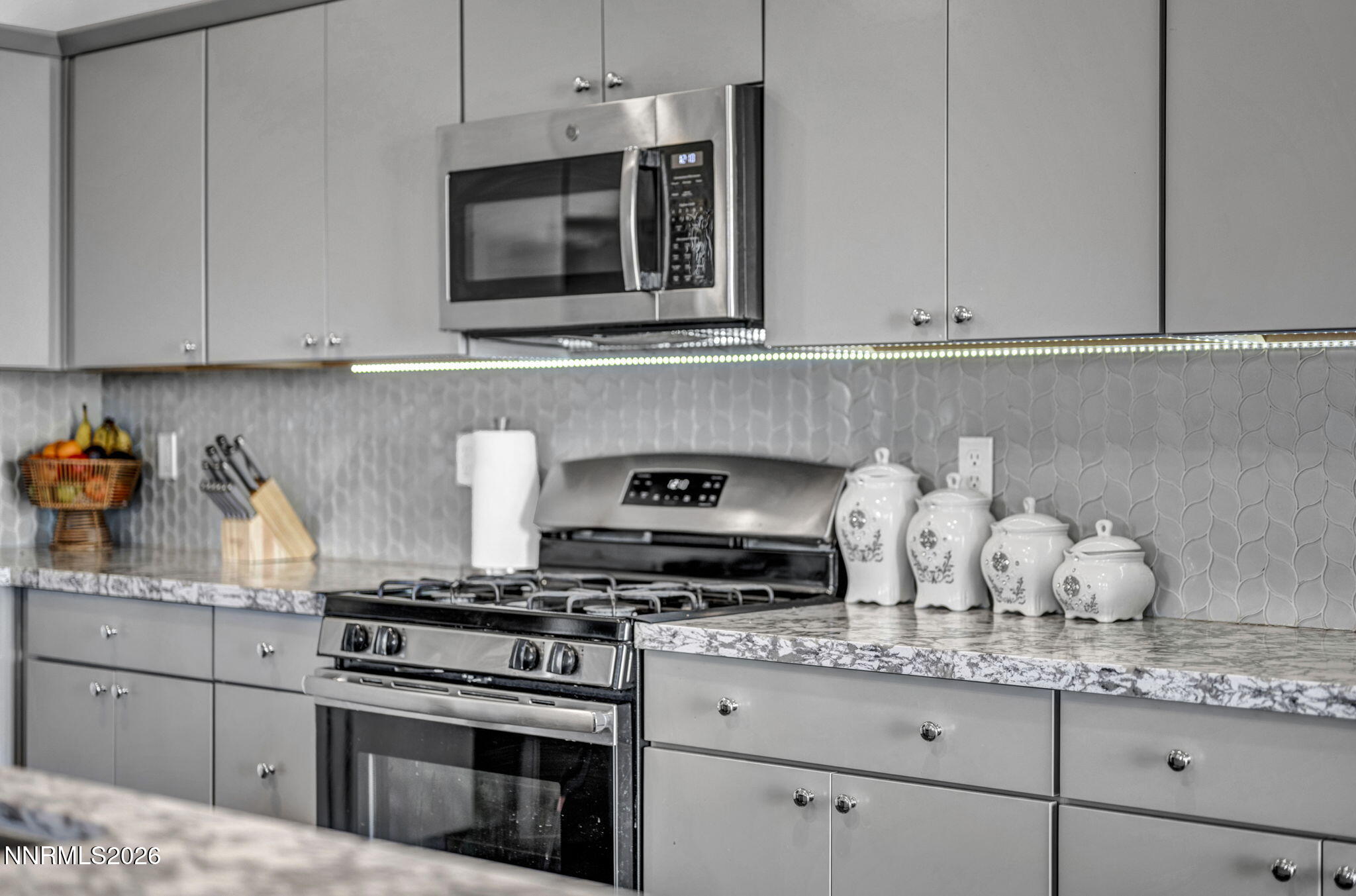 969 Estuary Circle Reno, NV 89506 - Photo 23 of 59 a kitchen with granite countertop white cabinets and appliances