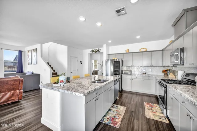 a kitchen with a sink stove and cabinets
