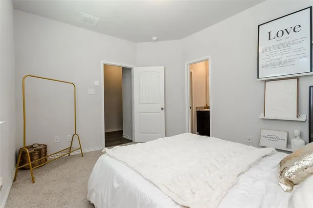 a bedroom with a bed and a chair