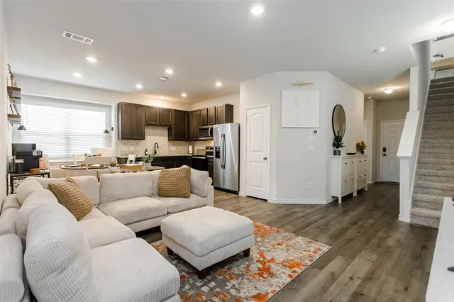 a living room with furniture and kitchen view