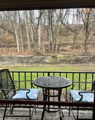 a view of a chairs and table on the roof deck