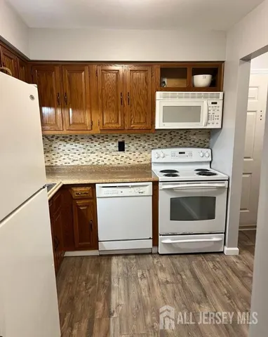 a stove top oven sitting inside of a kitchen