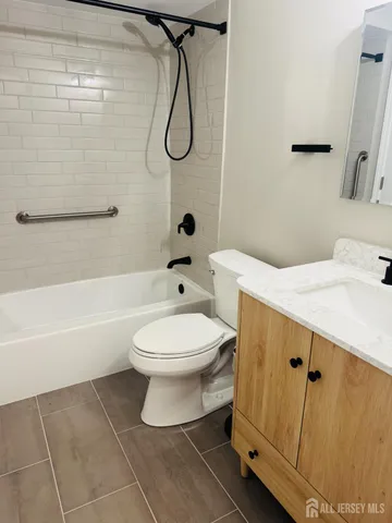 a bathroom with a toilet sink and shower