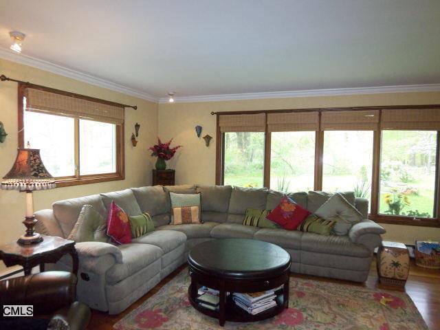 407 Den Road Stamford, CT 06903 - Photo 1 of 1 a living room with furniture and a large window