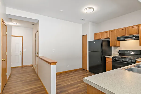 a kitchen with a sink a stove and refrigerator