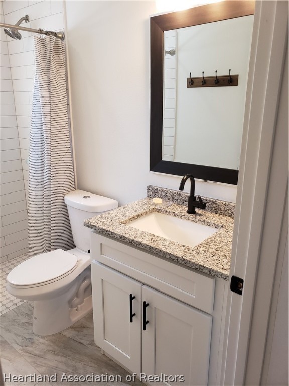 2247 West Longbottom Road Avon Park, FL 33825 - Photo 16 of 21 a bathroom with a granite countertop sink toilet and a mirror