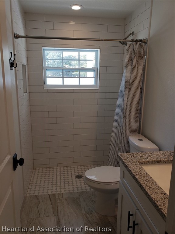 2247 West Longbottom Road Avon Park, FL 33825 - Photo 17 of 21 a bathroom with a granite countertop sink a toilet a window and shower