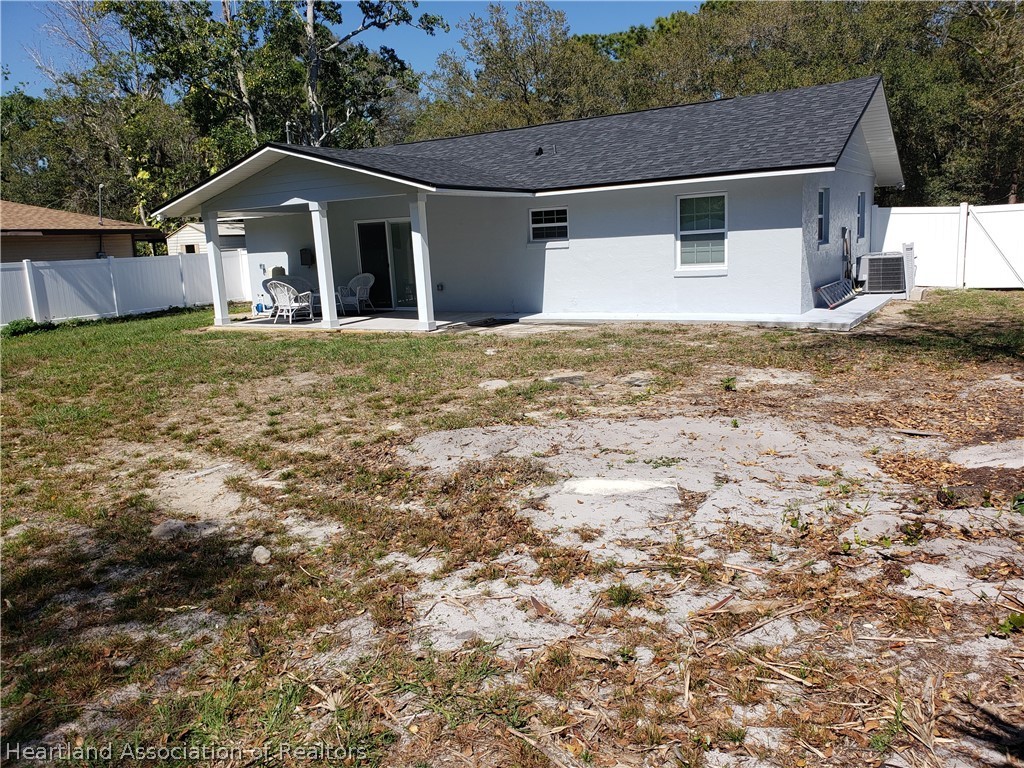 2247 West Longbottom Road Avon Park, FL 33825 - Photo 20 of 21 a front view of a house with a yard and garage
