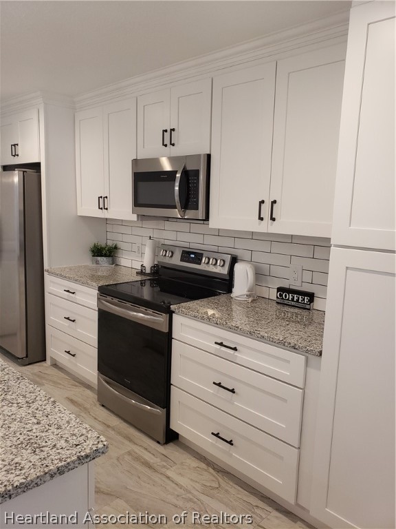 2247 West Longbottom Road Avon Park, FL 33825 - Photo 7 of 21 a kitchen with granite countertop white cabinets and stainless steel appliances