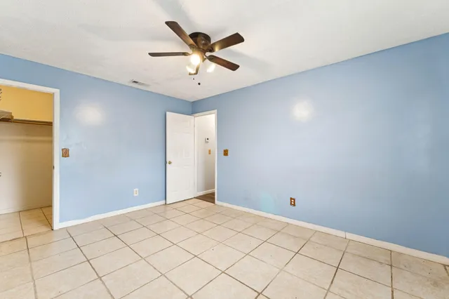 a view of a livingroom with a chandelier fan