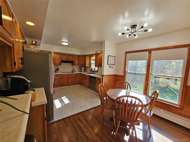 a view of a dining room with furniture a chandelier and wooden floor