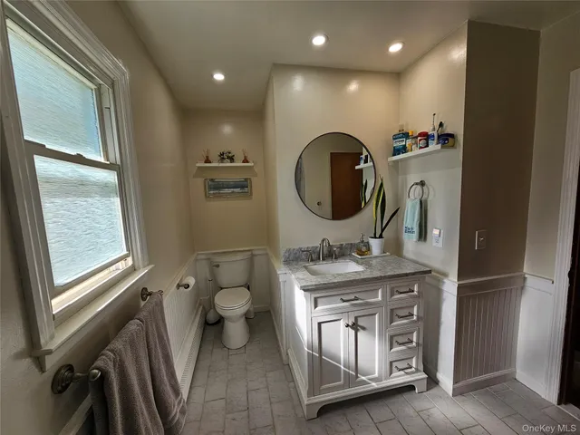 a bathroom with a granite countertop double vanity sink and a mirror