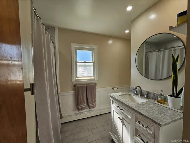 a bathroom with a toilet a sink and a mirror