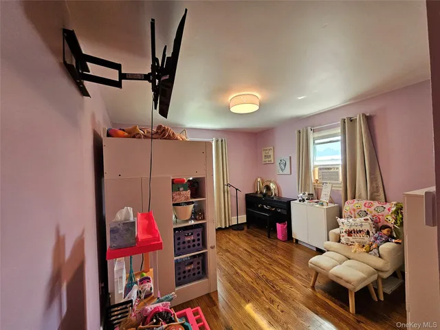 a bedroom with furniture and wooden floor